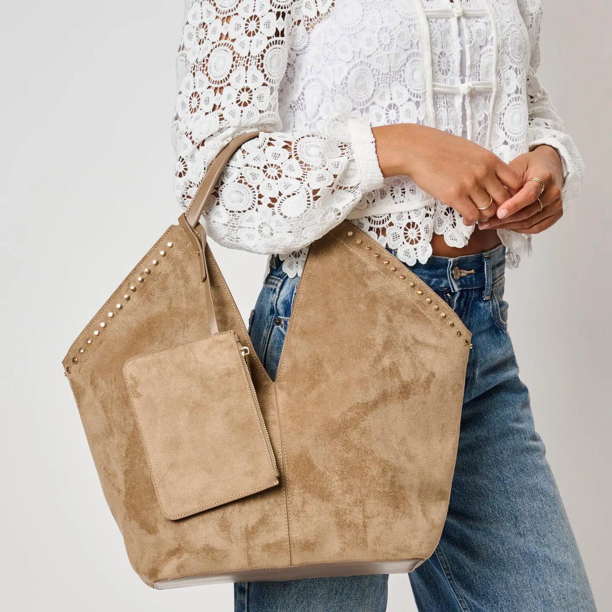 Close-up of Miranda Tote tan suede with gold studs and front zip pouch pocket