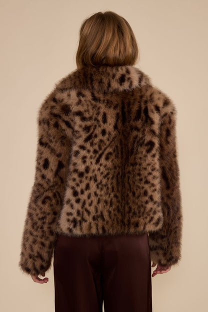 Back view of brown leopard print faux fur jacket on model with burgundy trousers